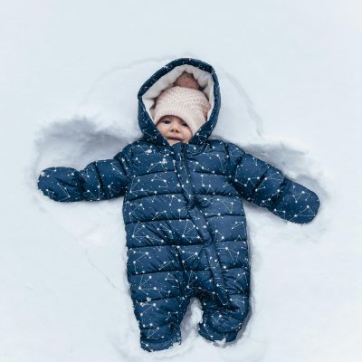 Baby in Snowsuit Lying in Snow 